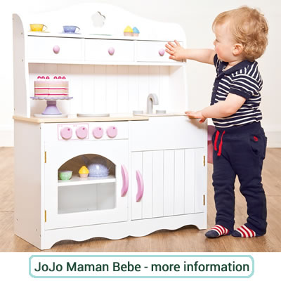 Small, white wooden play kitchen with pink knobs and door handles. 
